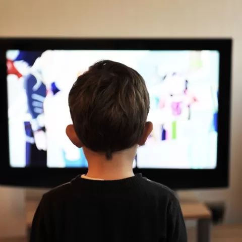 A child in front of a tv